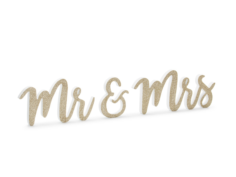 Zbliżenie na złoty brokat napisu Mr & Mrs